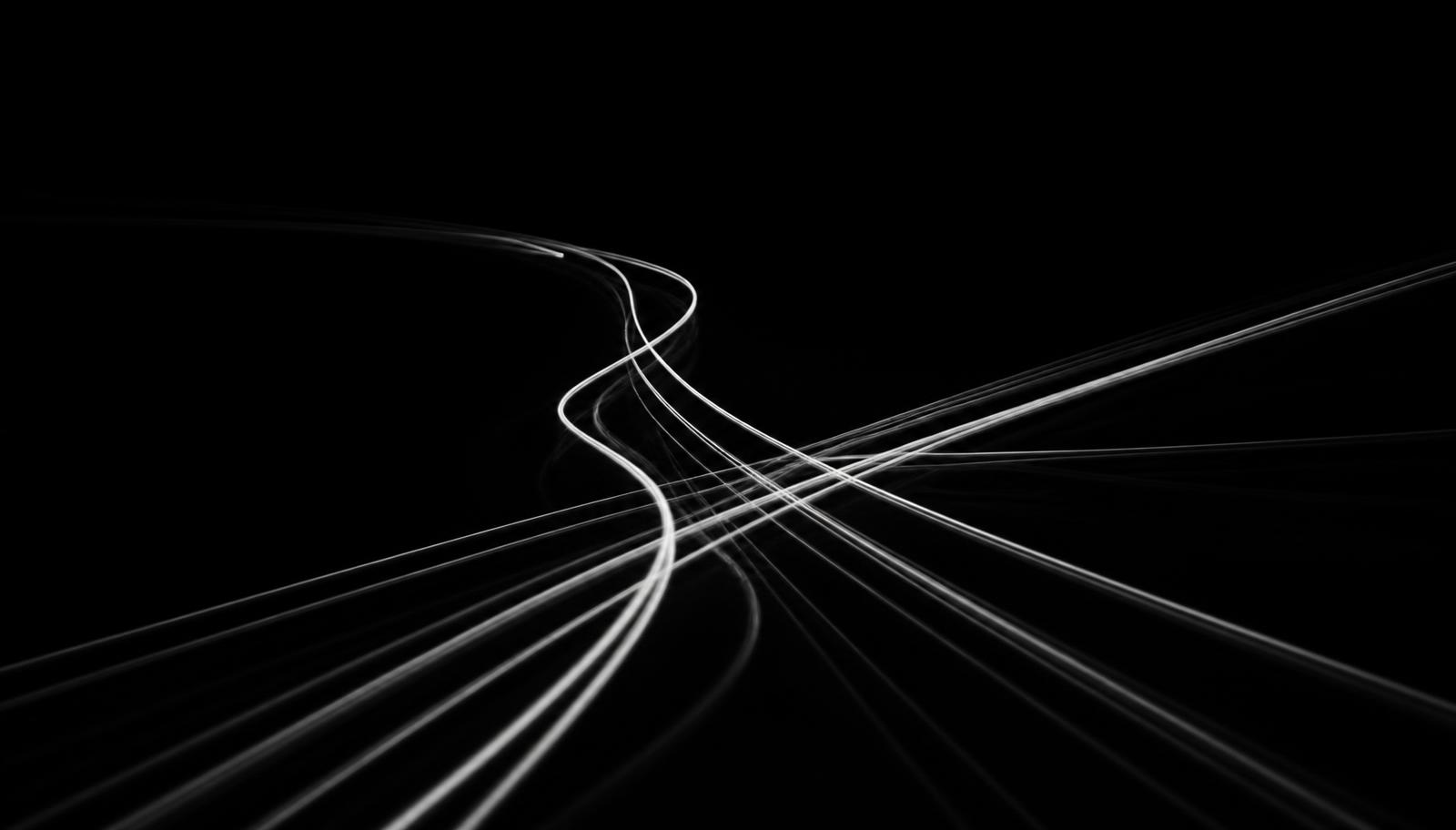 White light trails converging and separating against a black background, suggesting parallel workstreams