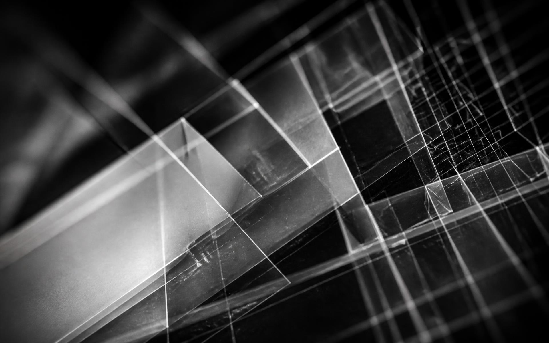 Abstract monochrome photograph of intersecting translucent planes and ruled lines